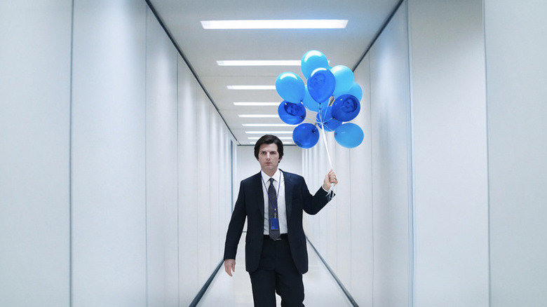 Adam Scott's Mark S. holding blue balloons in a Lumon hallway on Severance