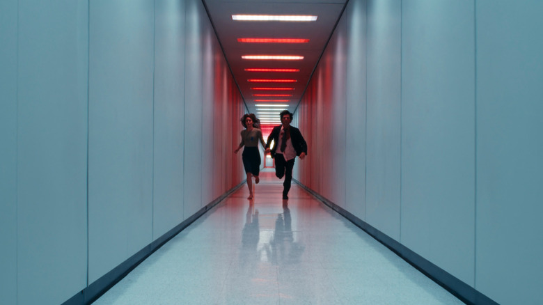 Britt Lower as Helly R. and Adam Scott as Mark S. running together down a hallway in Severance