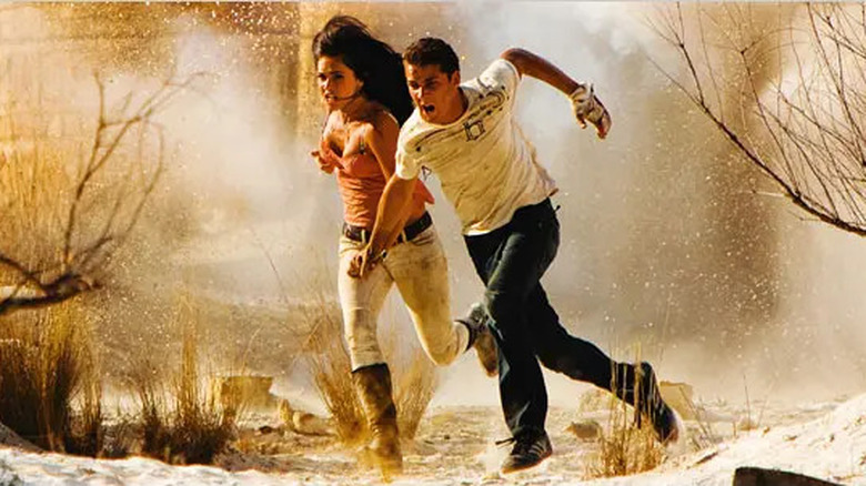 Mikaela Banes (Megan Fox) and Sam Witwicky (Shia LeBeouf) flee in Transformers: Revenge of the Fallen (2009)