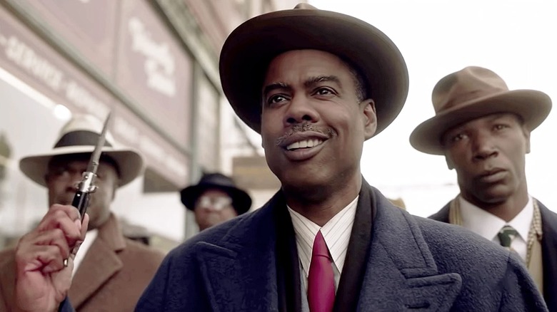 Chris Rock grinning with knife