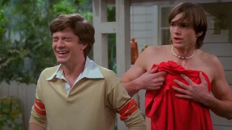 Eric laughs as Kelso is shirtless