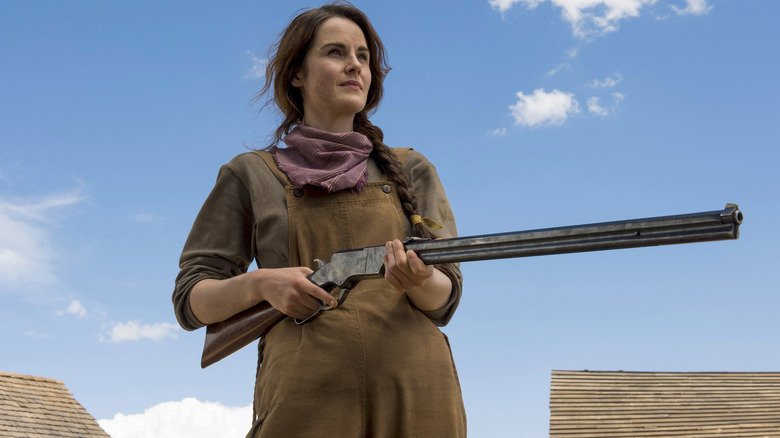 Michelle Dockery holding shotgun