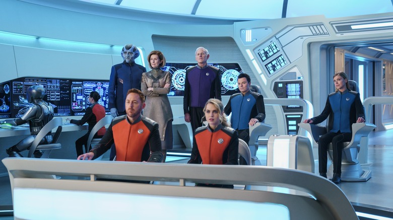 Orville Crew stands on Bridge