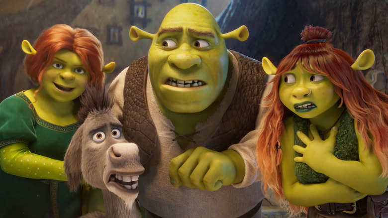 Fiona, Shrek, Donkey, and Shrek's daughter gathered in front of the Magic Mirror in Shrek 5