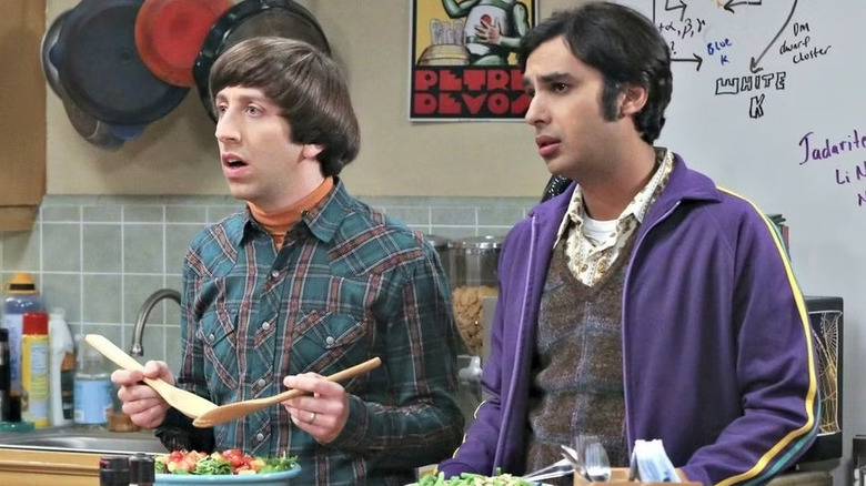 Howard and Raj look concerned and mix salads in the kitchen on the theory of the Big Bang