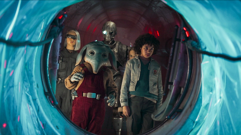 A group of children and a droid stare down a tunnel in Star Wars: Skeleton Crew