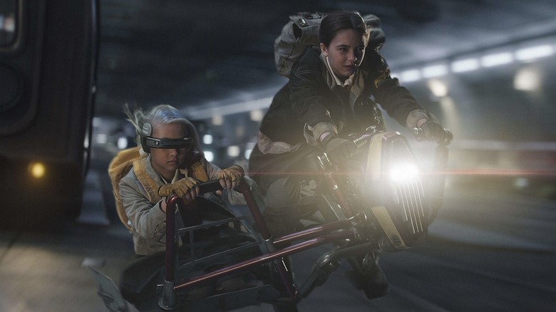 Fern and KB riding a speeder through traffic in Star Wars: Skeleton Crew