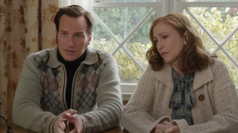 Ed and Lorraine Warren in front of a window