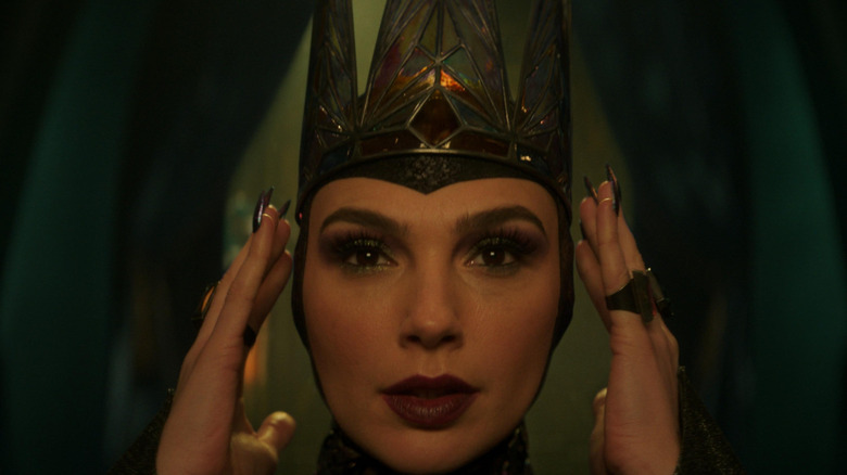 The Evil Queen putting on her crown from the 2025 version of Snow White.