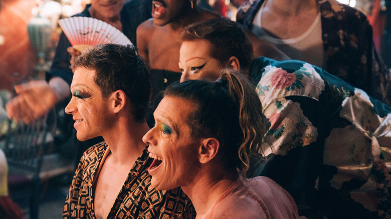 drag queens smiling together laughing