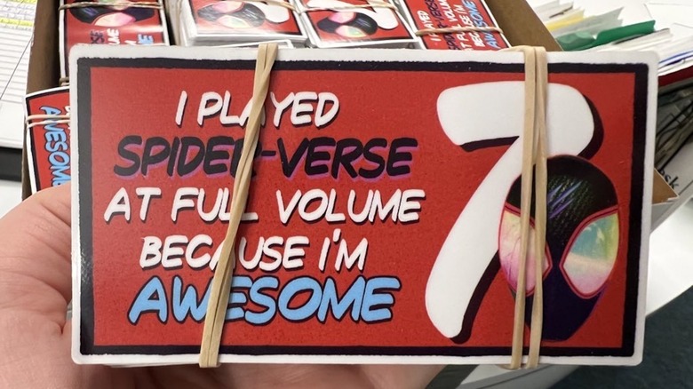 Custom made stickers to encourage projectionists to blast the volume for Across the Spider-Verse