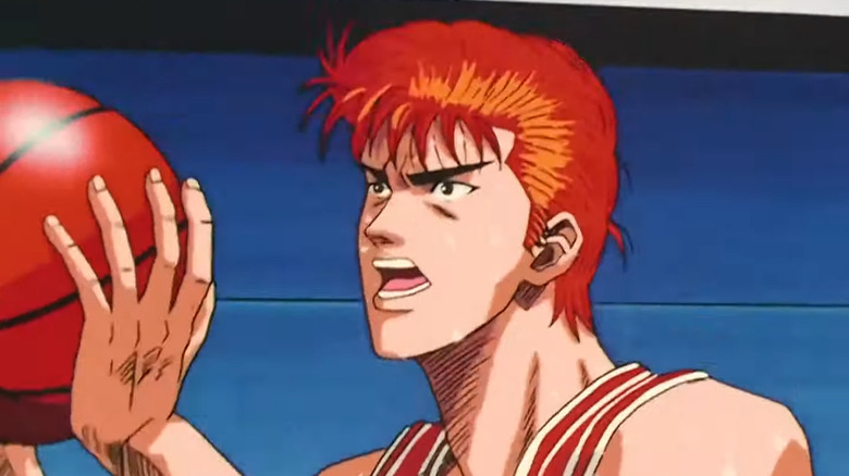 Hanamichi Sakuragi holding a basketball during a game in Slam Dunk