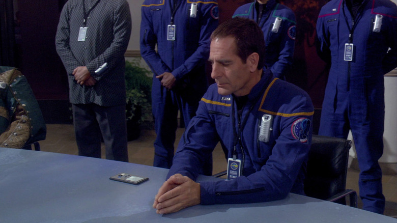 Captain Archer sitting at a diplomatic summit, his officers standing behind him in Star Trek: Enterprise