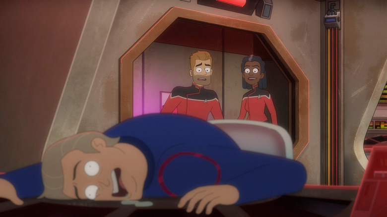 Jack Ransome and Captain Freeman looking shocked as they observe a seemingly dead man in the foreground in Star Trek: Lower Decks