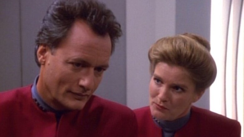 Q and Janeway standing together