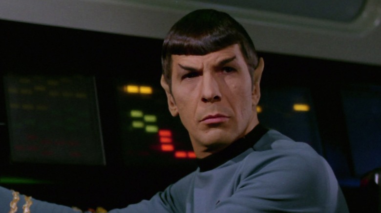 Leonard Nimoy's Spock observes something from his station on the bridge in Star Trek: The Original Series