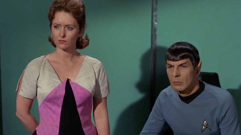 Kirk, in the body of Dr. Janice Lester, standing next to Spock