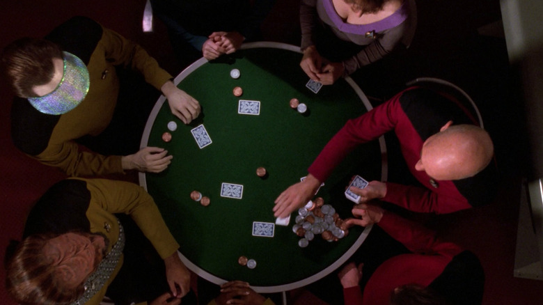 An overhead shot of a poker table, surrounded by the main cast of Star Trek: The Next Generation.