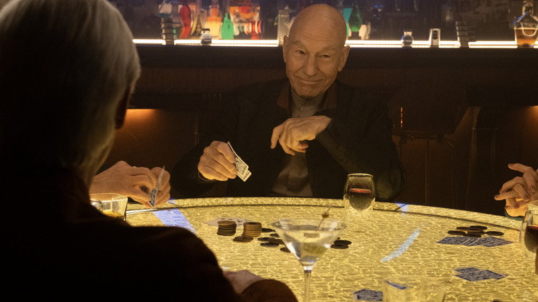 Picard sitting at a poker table in Guinan's bar, a shot from Star Trek: Picard.