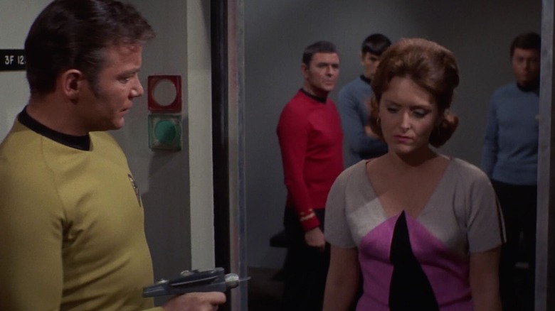 Dr. Lester in the body of Captain Kirk, holding a phaser on Captain Kirk, in the body of Janice Lester. From Star Trek.