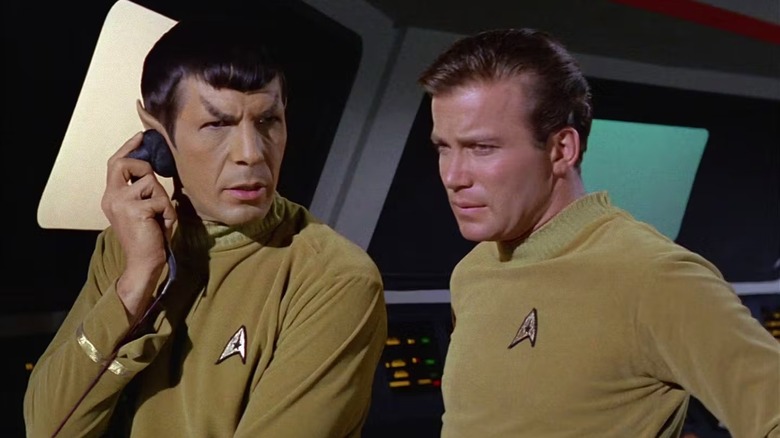 Spock (Leonard Nimoy) tells Kirk (William Shatner) what he overhears in Star Trek: The Original Series