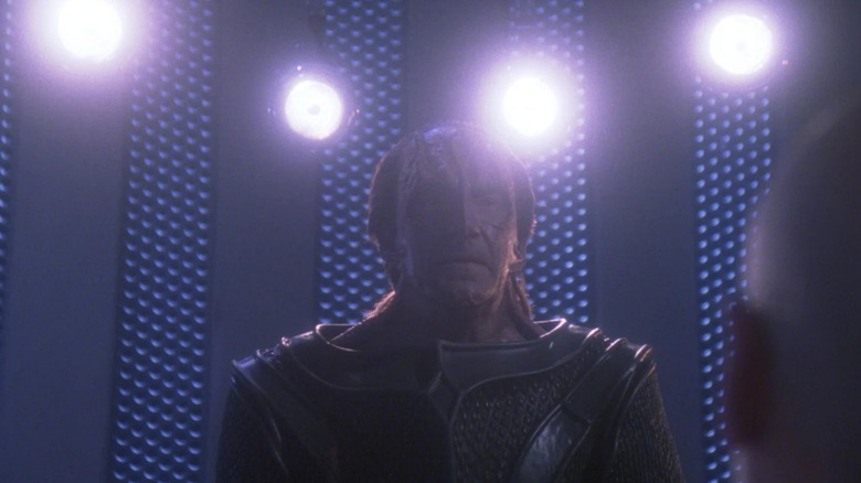 Picard's torturer (David Warner) framed by four lights while demanding his charge see five in TNG's Chain of Command