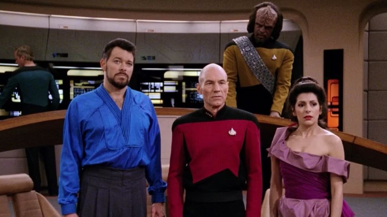 Riker (Jonathan Frakes), Picard (Stewart) Worf (Michael Dorn) and Troi (Marina Sirtis) confront an unseen Ferengi in TNG's Menage a Troi