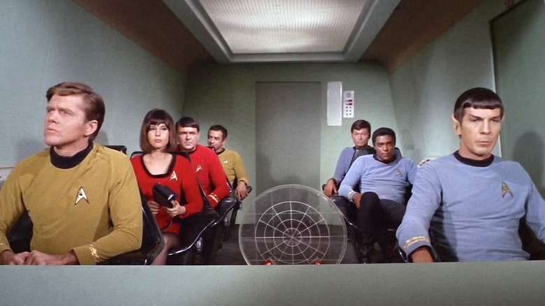 Spock (Leonard Nimoy) sits with his shuttle crew in Star Trek: The Original Series