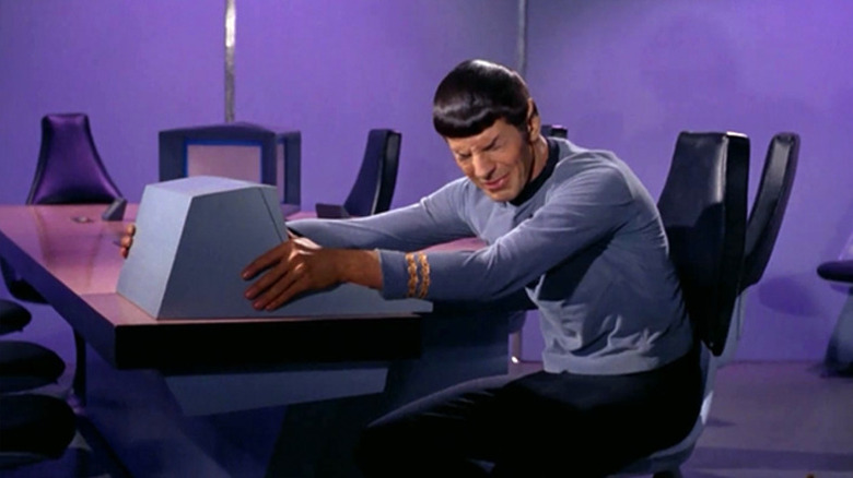 Spock (Leonard Nimoy) cries while holding a monitor in Star Trek: The Original Series