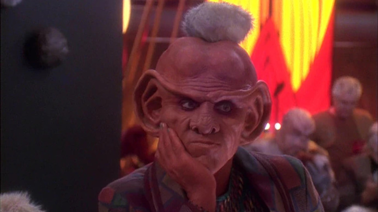 A thoughtful Quark (Armin Shimerman) with a Tribble on his head on Star Trek: Deep Space Nine