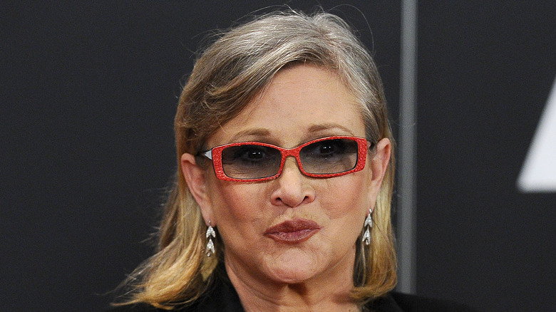 Carrie Fisher wears red glasses at media event