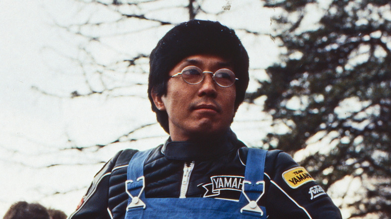 Eiji Kusuhara stands at a German rally