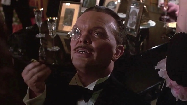 Jack Purvis wearing a suit and monocle in "Brazil"