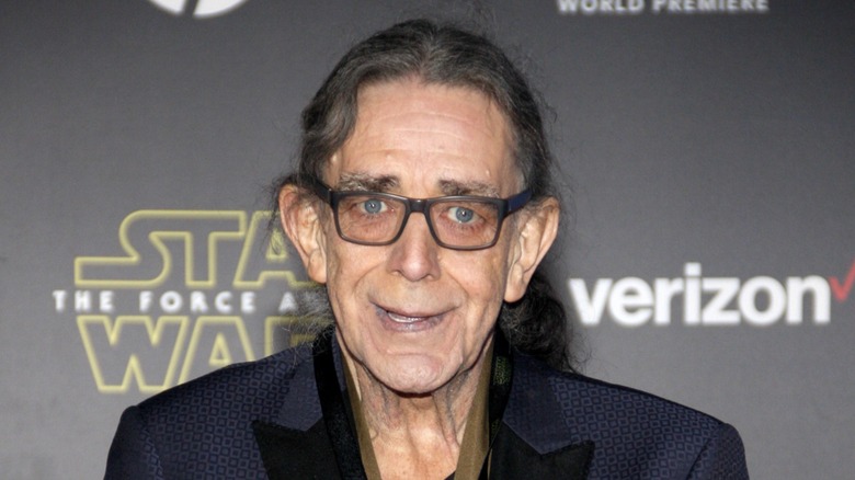 Peter Mayhew wears a blue jacket to a "Star Wars" event