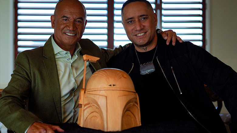 Temuera Morrison and artist ﻿Graham Hoete, aka MrG, with Māori carving of Boba Fett's helmet