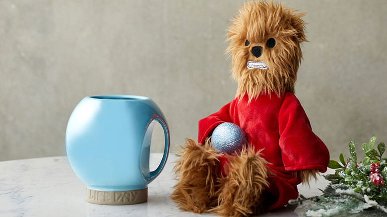 Select Life Day merchandise, including a plush Chewbacca in red Life Day robe.