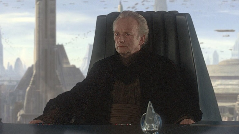 Ian McDiarmid's Palpatine sitting at his desk in Star Wars: Revenge of the Sith