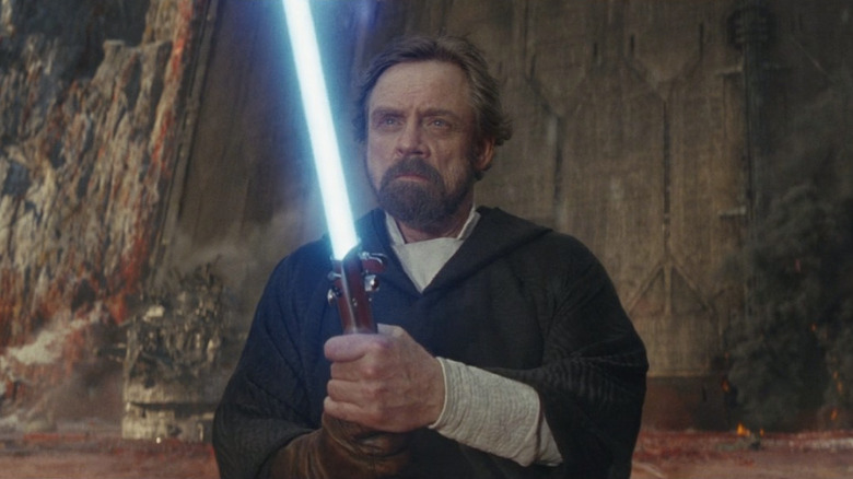 Luke Skywalker with lightsaber on Crait