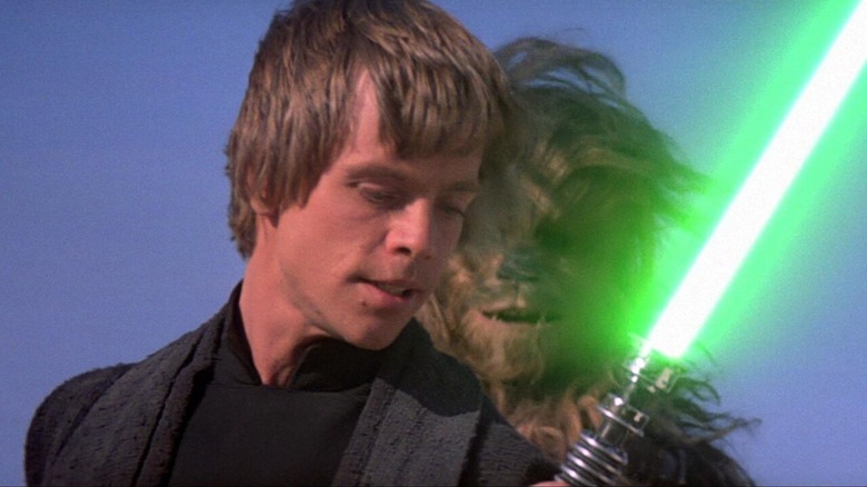 Mark Hamill as Luke Skywalker fires up a lightsaber in Star Wars: Episode VI - Return of the Jedi