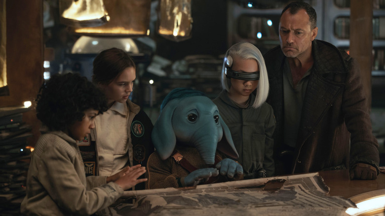 Wim, Fern, Neel, KB, and Jod looking at a map in Star Wars: Skeleton Crew