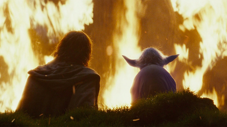 Luke e Yoda assistem a um incêndio em Star Wars: Os Últimos Jedi