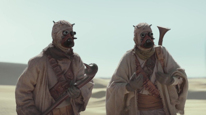 Two Tusken Raiders communicating via sign language in The Mandalorian