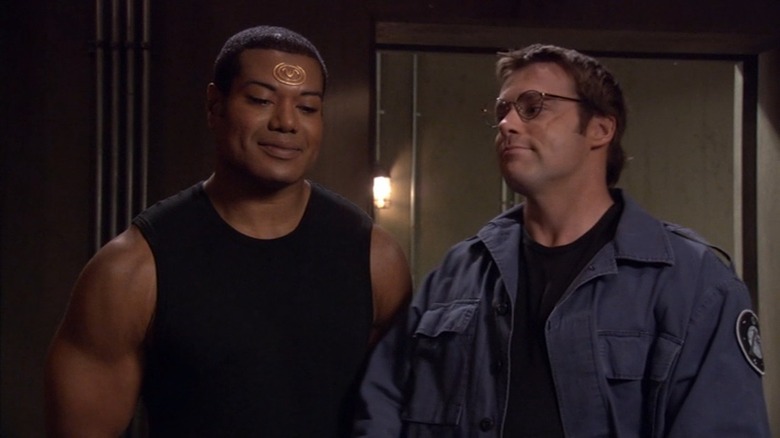 Christopher Judge as Teal'c and Michael Shanks as Daniel Jackson are smiling awkwardly on Stargate SG-1