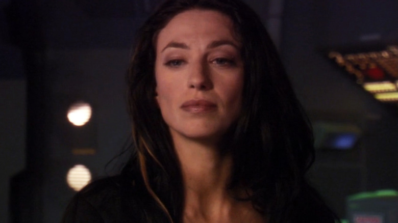 Claudia Black's Vala Mal Doran stands inside a command center in Stargate SG-1