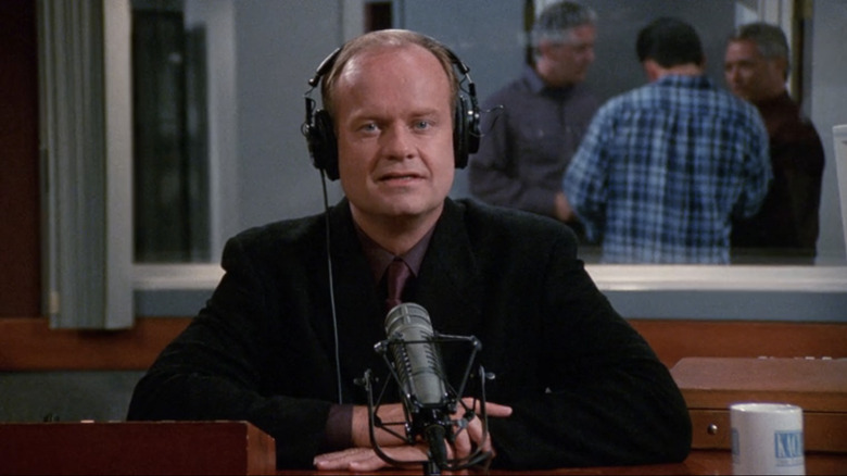 Kelsey Grammer's Frasier sits at his desk in the KACL radio studio in Frasier