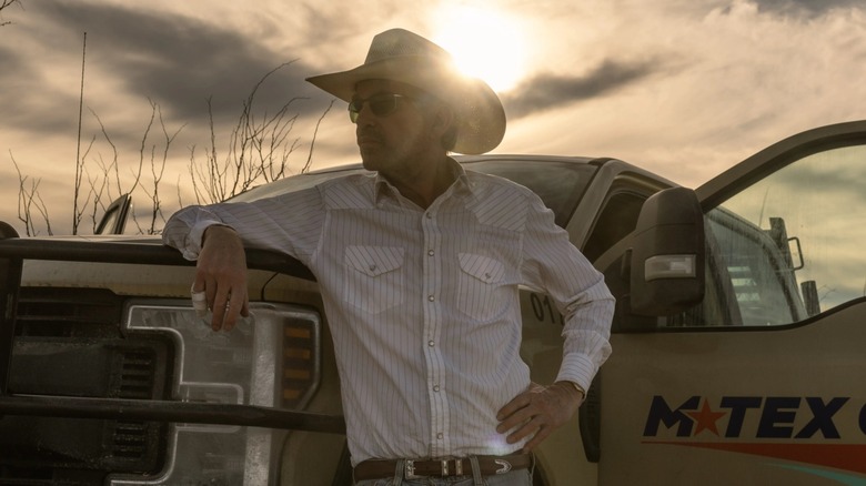 Tommy Norris leaning against a truck in Landman