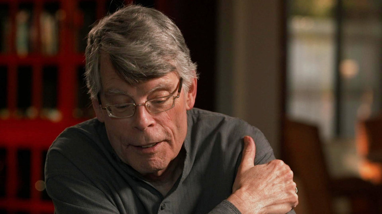 Stephen King sitting with his arms folded on Finding Your Roots