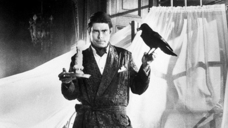 Stephen King poses with a candle and a raven from his American Express commercial.