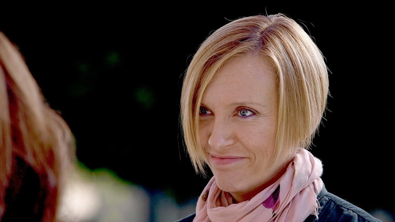 Tara (Toni Collette) smiles as she looks at someone offscreen in 