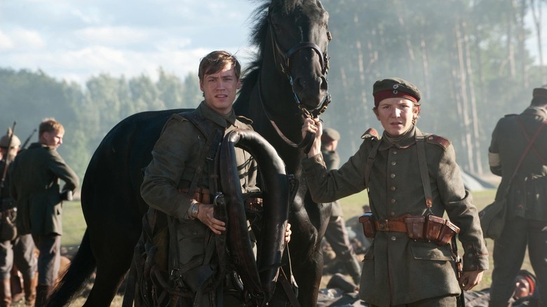 men saddling a horse War Horse